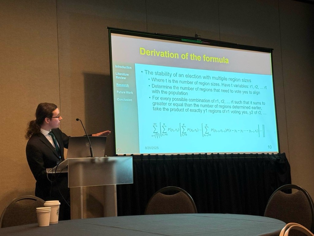 Jared Hirt presenting derivation slides at IEEE UIC